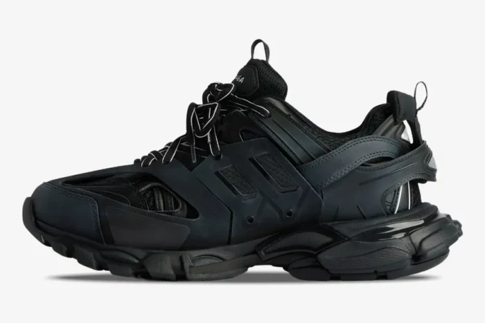 Side profile view of Balenciaga Track black mesh and nylon sneakers on a white background. - SKU 542023W1GB11000