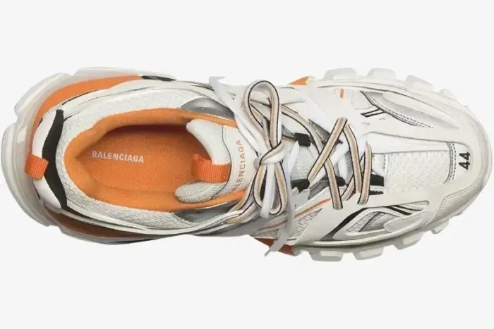 Top-down view of a Balenciaga Track Sneaker in white, orange, and black with complex layered design. - SKU 542023W1GB19059