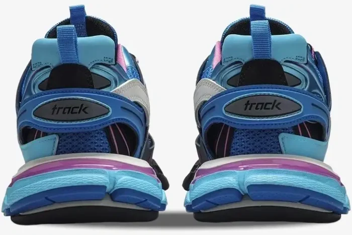 Rear view of Balenciaga Track Trainer sneakers in light blue and pink, showing the 'track' logo on the heels. - SKU 542023W1GB54162