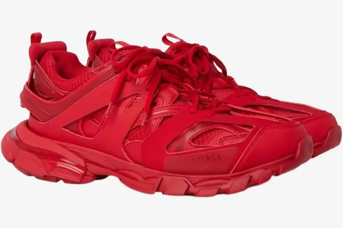 A pair of monochromatic red Balenciaga Track Trainers shown from a three-quarter side perspective. - SKU 542023W2LA16000
