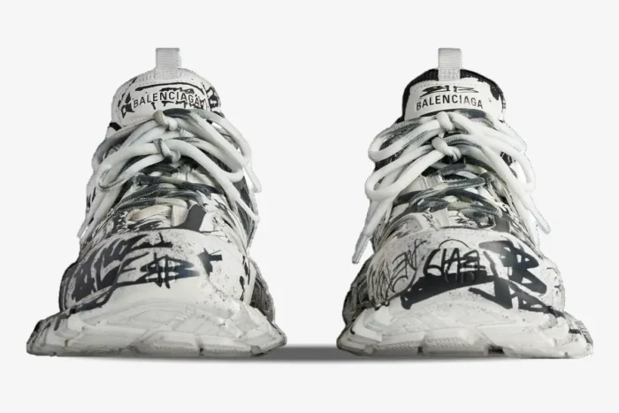 Front view of Balenciaga Track sneakers in white with black graffiti print and white laces. - SKU 542023W3RRA9010