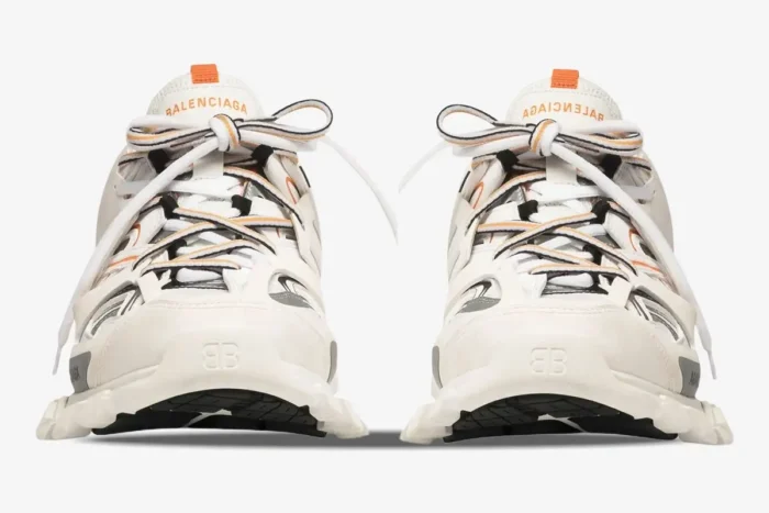 Front view of Balenciaga Track sneakers in white and orange with layered mesh and nylon. - SKU 542023W1GB19059