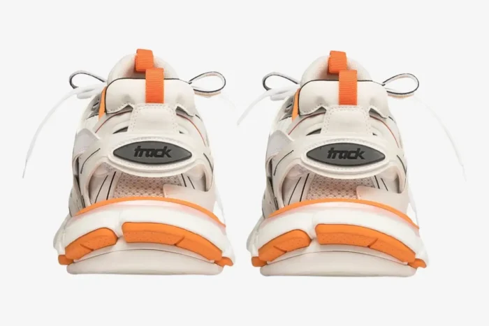 Rear view of Balenciaga Track sneakers in white and orange with chunky soles. - SKU 542023W1GB19059