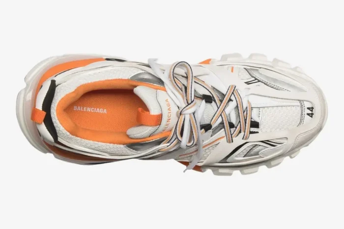 Top-down view of a Balenciaga Track sneaker in white and orange with layered mesh and nylon panels. - SKU 542023W1GB19059