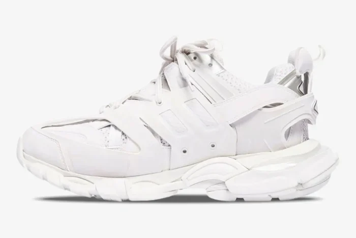 Side profile of white Balenciaga Track multi-layered sneakers with chunky soles and mesh panels. - SKU 542023W1GB19000