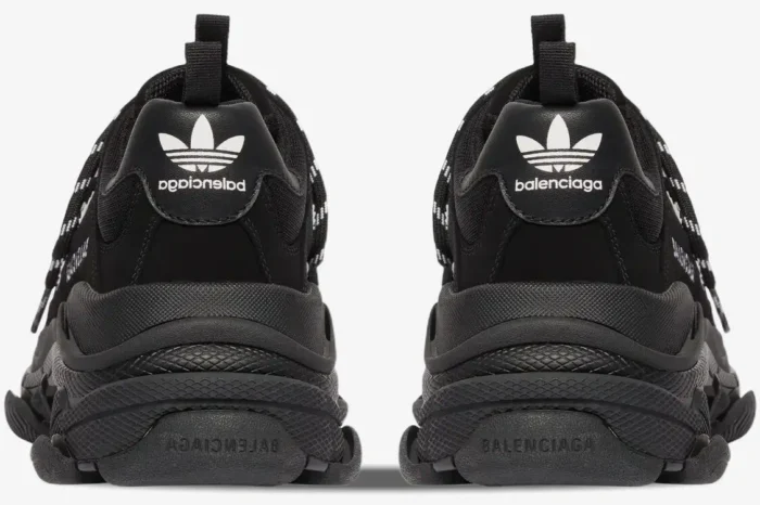 Rear view of black Balenciaga Triple S x Adidas sneakers showing mirrored heel branding and soles. - SKU 712821W2ZB21090