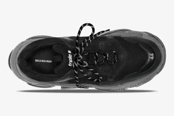 Top-down view of a black Balenciaga Triple S sneaker with patterned laces and clear sole. - SKU 541624W2FB11000