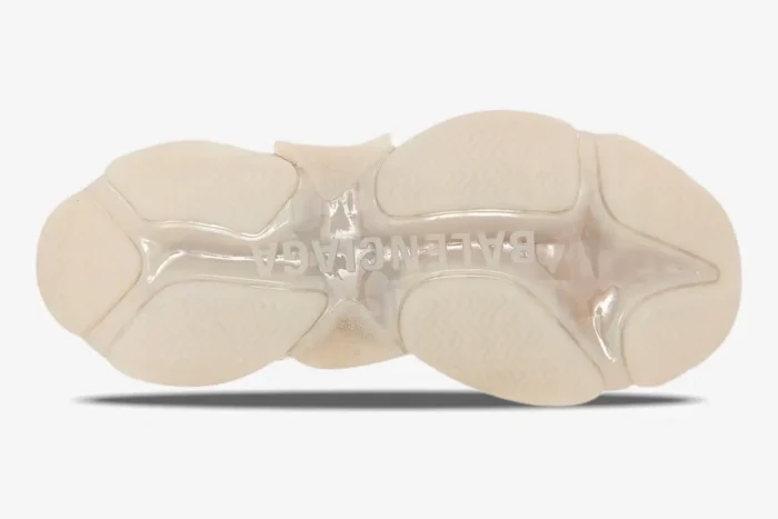 Bottom view of Balenciaga Triple S Clear Sole Sneaker in off-white, showing the translucent outsole and logo. - SKU 541624W2FB19005