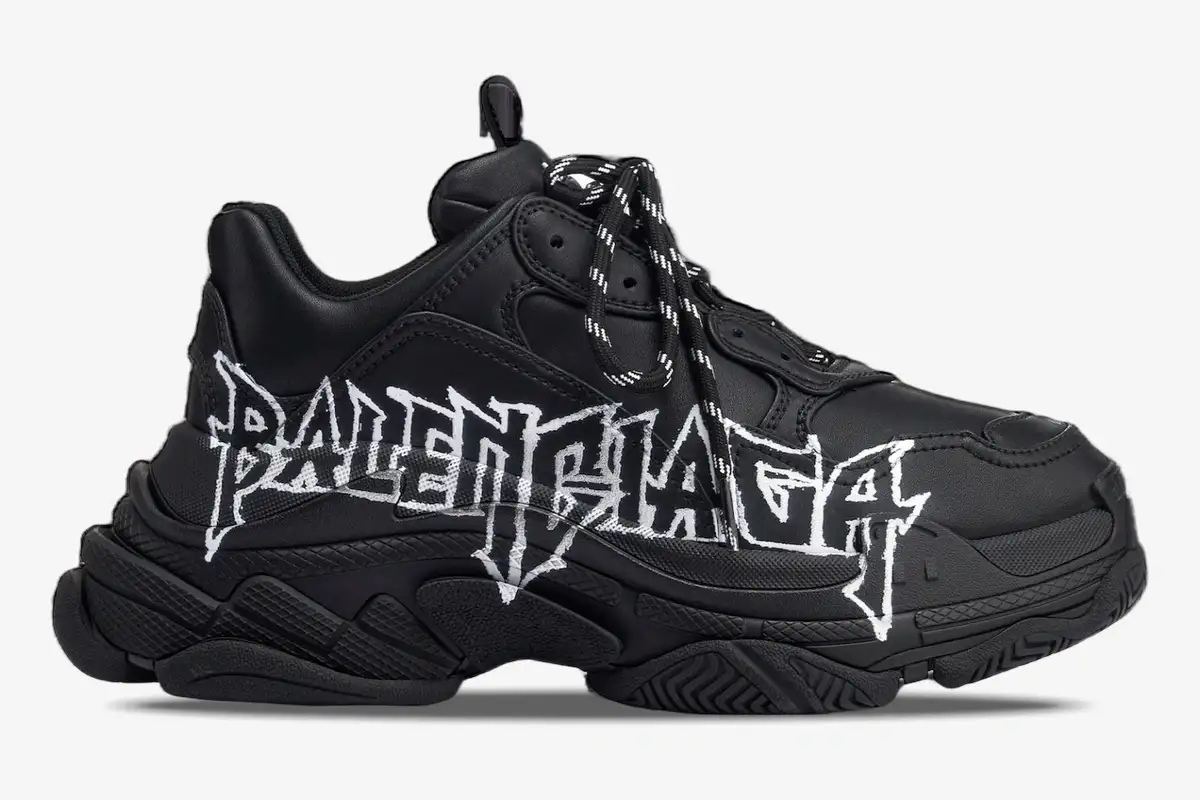 balenciaga-triple-s-diy-metal-artwork-black-side-536737w2fay1090-634-864 Side view of a black Balenciaga Triple S sneaker featuring white DIY metal-style graffiti artwork on the side. - SKU 536737W2FAY1090