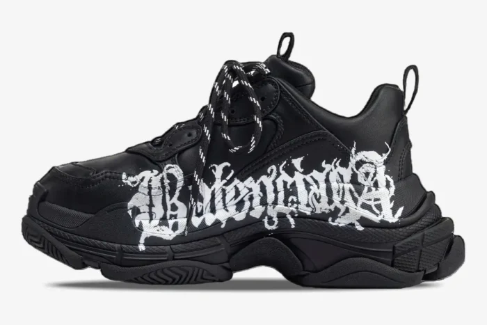 Side profile of black Balenciaga Triple S DIY Metal Artwork sneakers with white graffiti logo. - SKU 536737W2FAY1090