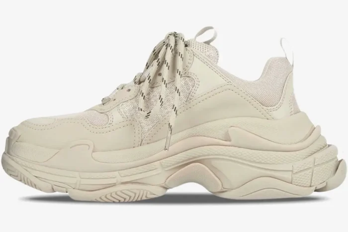 Side profile of a beige Balenciaga Triple S sneaker with a chunky triple-layered sole. - SKU 524039W2FW19700