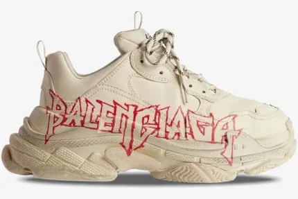 Side view of a beige Balenciaga Triple S sneaker with red graffiti-style logo on the chunky sole and upper. - SKU 524039W2FA19010