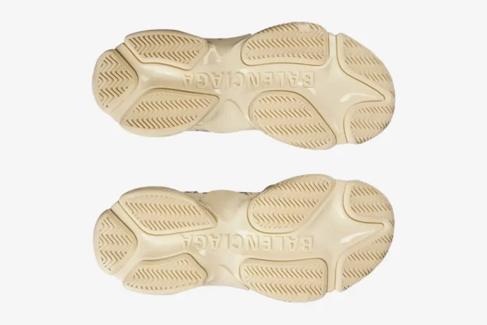 Bottom view of beige Balenciaga Triple S Graffiti sneakers showing the chunky textured outsoles. - SKU 524039W2FA19010