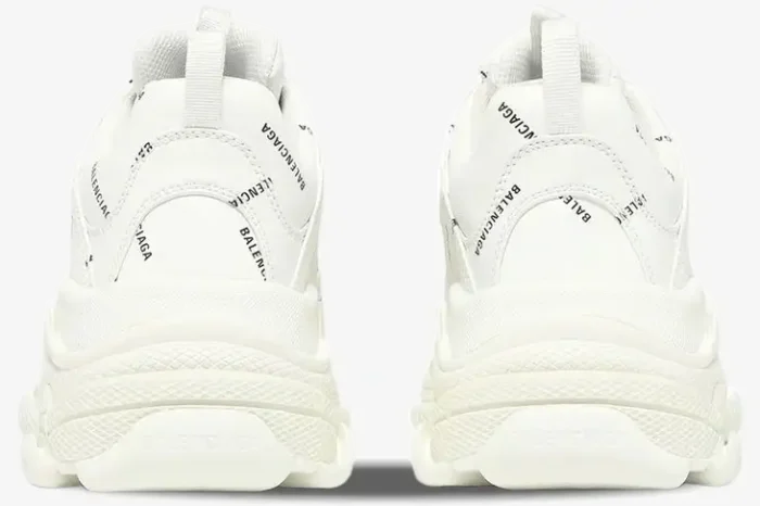 Rear view of white Balenciaga Triple S sneakers with black all-over logo print and chunky soles. - SKU 536737W2FA19010