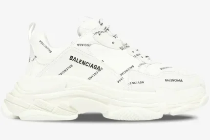 White Balenciaga Triple S sneaker with black all-over logo print, side profile view on a white background. - SKU 536737W2FA19010
