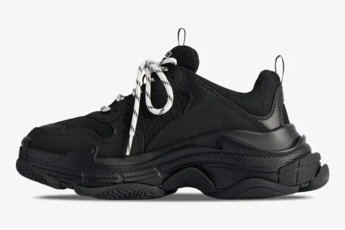 Black Balenciaga Triple S chunky sneaker in a side profile view with white patterned laces. - SKU 536737WTRST1070