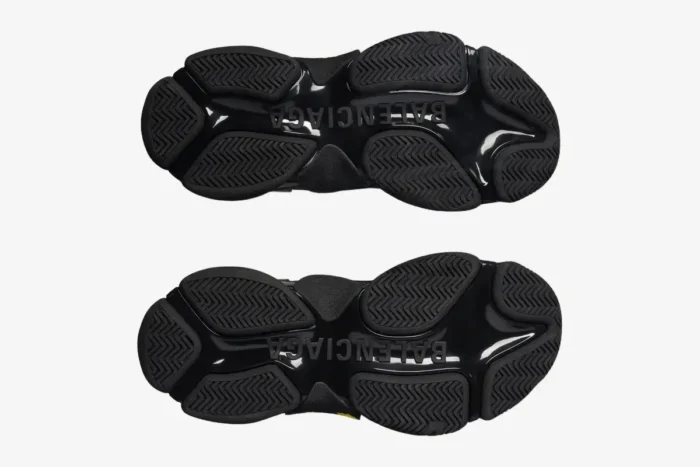 Bottom view of black and yellow Balenciaga Triple S Tapa Type sneakers showing the chunky outsole. - SKU 536737WTRST1070