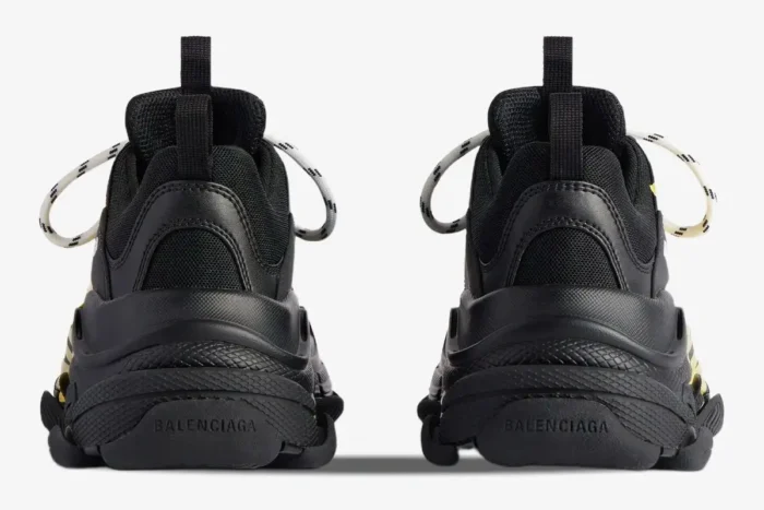 Rear view of Balenciaga Triple S Tapa Type sneakers in black with yellow accents. - SKU 536737WTRST1070