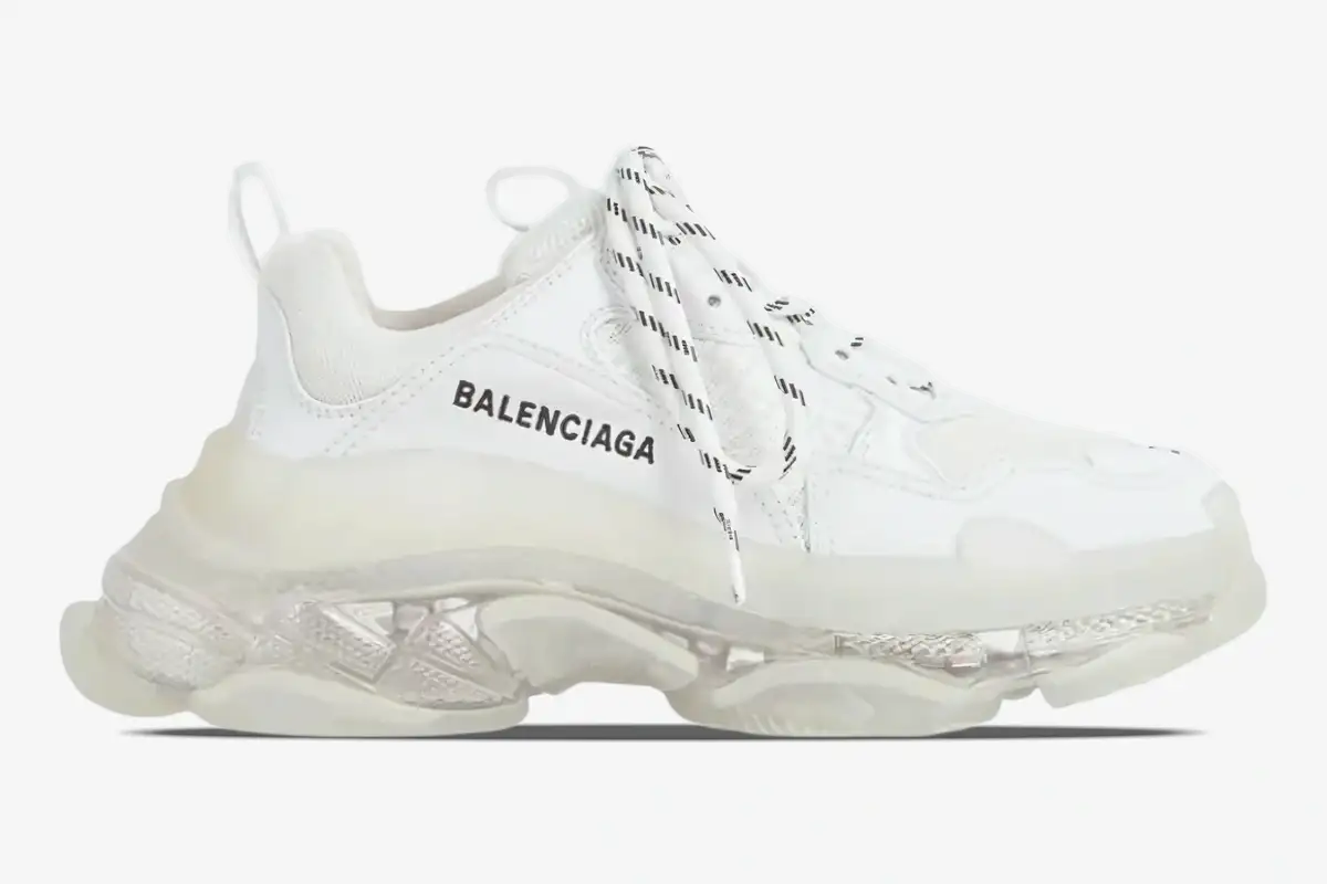 balenciaga-triple-s-white-clear-sole-side-544351w2fb19000-174-481 Side profile of a white Balenciaga Triple S sneaker with a chunky clear sole and black logo. - SKU 544351W2FB19000