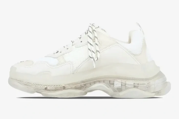 Side profile of a white Balenciaga Triple S sneaker with a chunky clear translucent sole. - SKU 544351W2FB19000