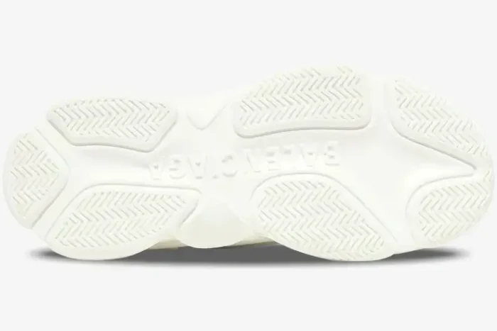 Bottom view of the white Balenciaga Triple S sneaker sole showing the embossed logo and textured tread. - SKU 536737W2FA19010