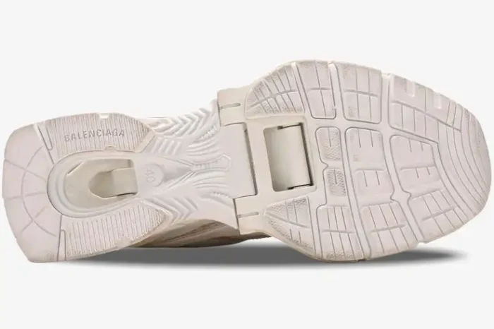 Bottom sole view of Balenciaga X-Pander sneakers in distressed beige white showing the suspended heel mechanism. - SKU 653871W2RA29000
