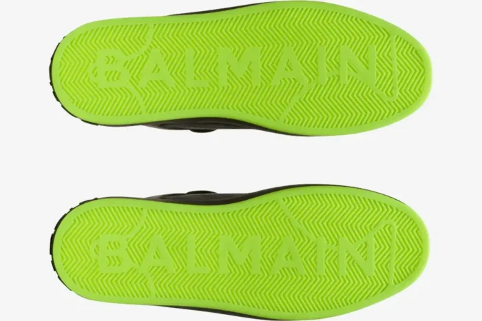 Bottom view of Balmain B-Court sneakers showing neon green soles with textured herringbone pattern and logo. - SKU AM1VI289LSYM