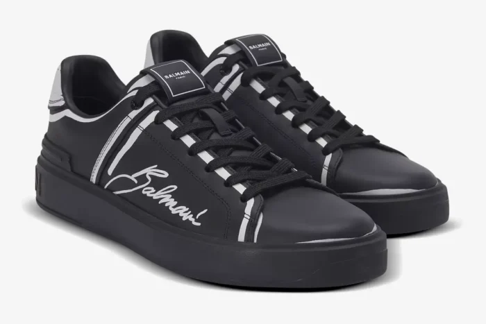 Balmain B-Court black and white calfskin trainers, three-quarter front view showing script logo. - SKU EN1VI690LCLP