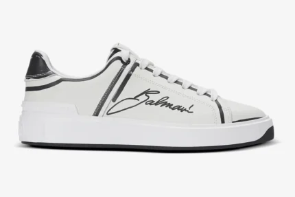 Side view of Balmain B-Court white calfskin low-top sneakers with black script logo and trim. - SKU EN1VI690LCLP