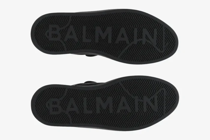 Bottom view of Balmain B-Court Flip Low-Top black sneakers showing the branded rubber outsoles. - SKU DN0VI727LBSO