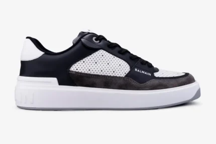 Side profile of Balmain B-Court Flip low-top sneakers in black, white, and grey with a thick white sole. - SKU AM1VI245LSEP