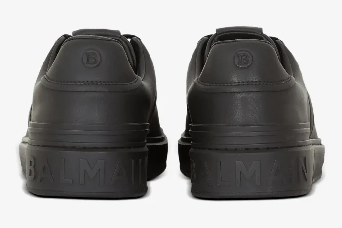 Rear view of black Balmain B-Court calfskin trainers showing embossed logo on the heel. - SKU GM1VI288LVTR