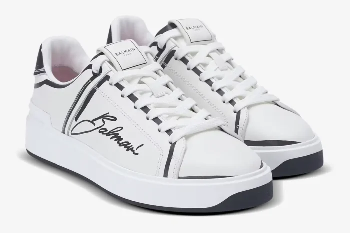 Balmain B-Court white low-top sneakers with black script logo, three-quarter view. - SKU EN1VI690LCLP