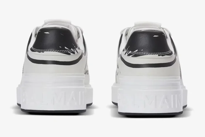 Rear view of white Balmain B-Court calfskin sneakers with black print and embossed logo on the heel. - SKU EN1VI690LCLP