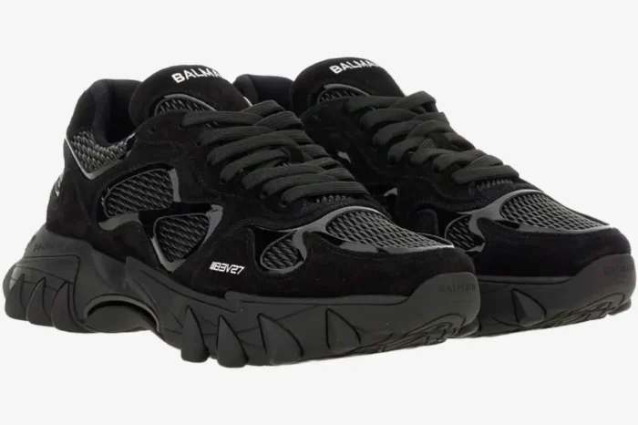 A pair of black Balmain B-East Low Top sneakers shown from a three-quarter front perspective. - SKU AM1VI327THPC-0PA