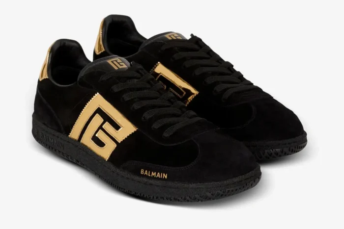 Black Balmain Swan goatskin suede sneakers with gold logo details, three-quarter view. - SKU AM1VI261LSGG