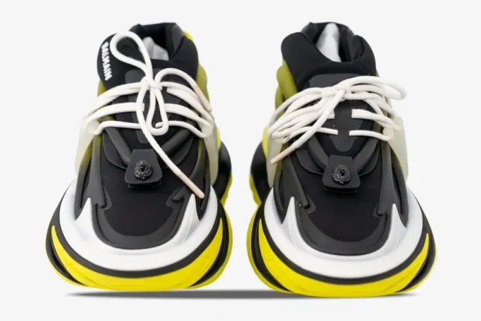 Front view of Balmain Unicorn Low-Top sneakers in black and yellow with white laces. - SKU YM0VJ309KNET
