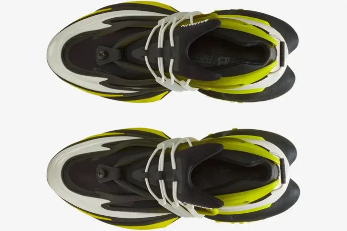 Top-down view of a pair of Balmain Unicorn Low-Top sneakers in black and neon yellow with white accents. - SKU YM0VJ309KNET