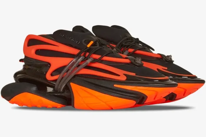 Balmain Unicorn Low-Top sneakers in vibrant orange and black, shown from a side profile angle. - SKU YM1VJ309KNCA