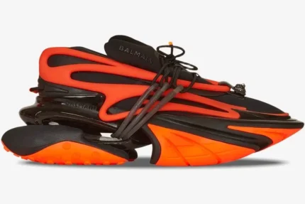 Balmain Unicorn low-top sneakers in orange and black, shown from a side profile view. - SKU YM1VJ309KNCA