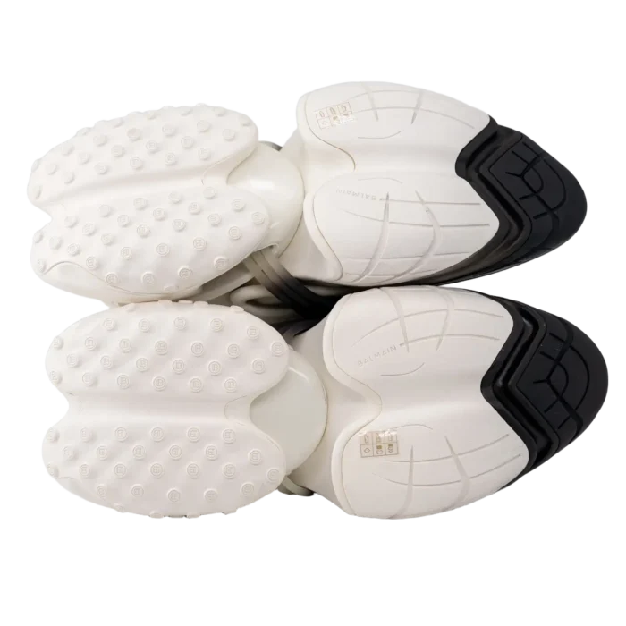 Bottom view of Balmain Unicorn Low Top white and black sneakers showing unique textured outsoles. - SKU YM0VJ309KNED-GAB