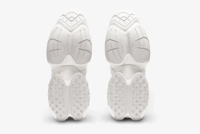 Bottom view of white Balmain Unicorn low-top sneakers showing the unique segmented outsole design. - SKU AM0VJ309KNLR