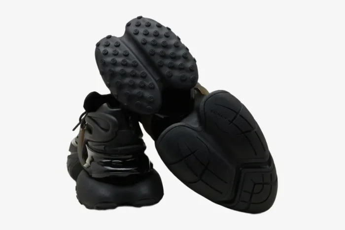 Rear and outsole view of Balmain Unicorn Chunky Sneakers in all black, showing unique tread patterns. - SKU BM1VJ309KNSC