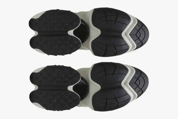 Bottom view of Balmain Unicorn Chunky Sneakers in black and white showing the unique textured outsoles. - SKU BN1VF724KNOC