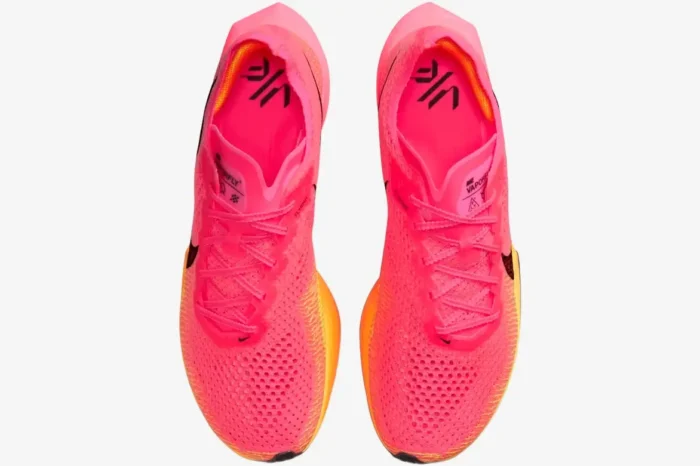 Top-down view of Nike ZoomX Vaporfly 3 performance runners in pink and orange. - SKU DV4129-600
