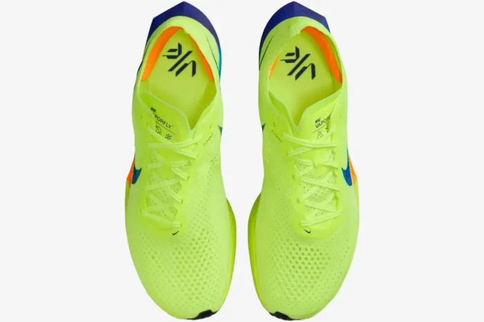 Top-down view of Nike ZoomX Vaporfly 3 marathon racing shoes in neon yellow, blue, and orange. - SKU DV4129-700