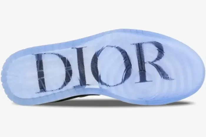Bottom view of Air Jordan 1 Low x Dior sneaker featuring a translucent icy blue outsole with a large navy logo. - SKU CN8608-002