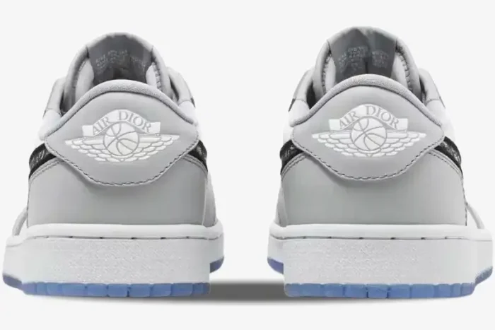 Rear view of Air Jordan 1 Low Retro x Dior sneakers in grey and white, featuring the Air Dior wings logo. - SKU CN8608-002