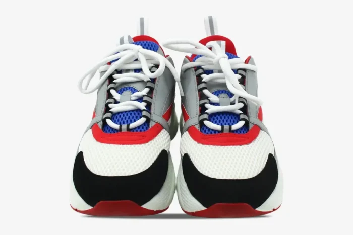 Front view of Dior B22 luxury sneakers in grey, red, blue, and white mesh with black accents. - SKU 3SN231YKB_H865