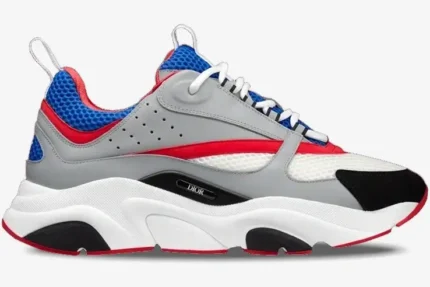 Side view of Dior B22 luxury sneakers in grey, red, and blue with a chunky white sole. - SKU 3SN231YKB_H865